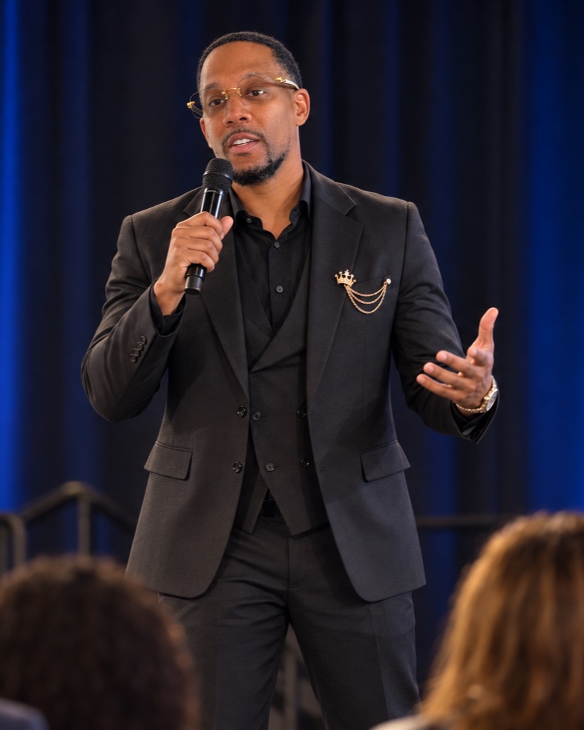 Chris Bruce on stage presenting to a live room